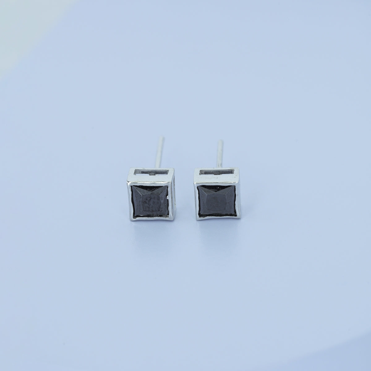 Black princess bezel stud earrings with channel set flat square frame