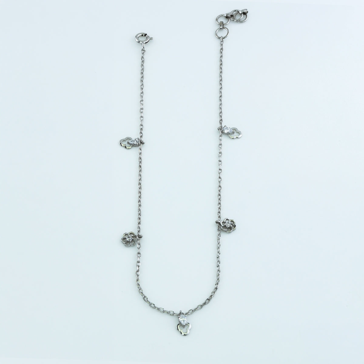 Floral and pear drop charm anklet with delicate chain and alternating flower and pear shaped dangling charms