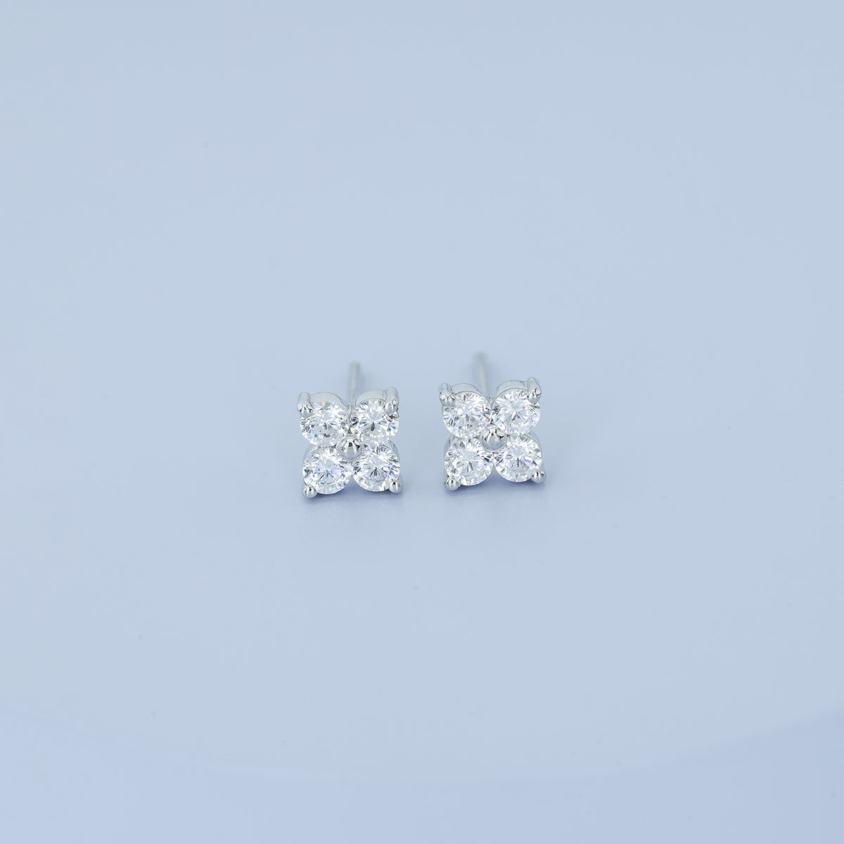 Floral diamond stud earrings with five round stones in flower cluster arrangement