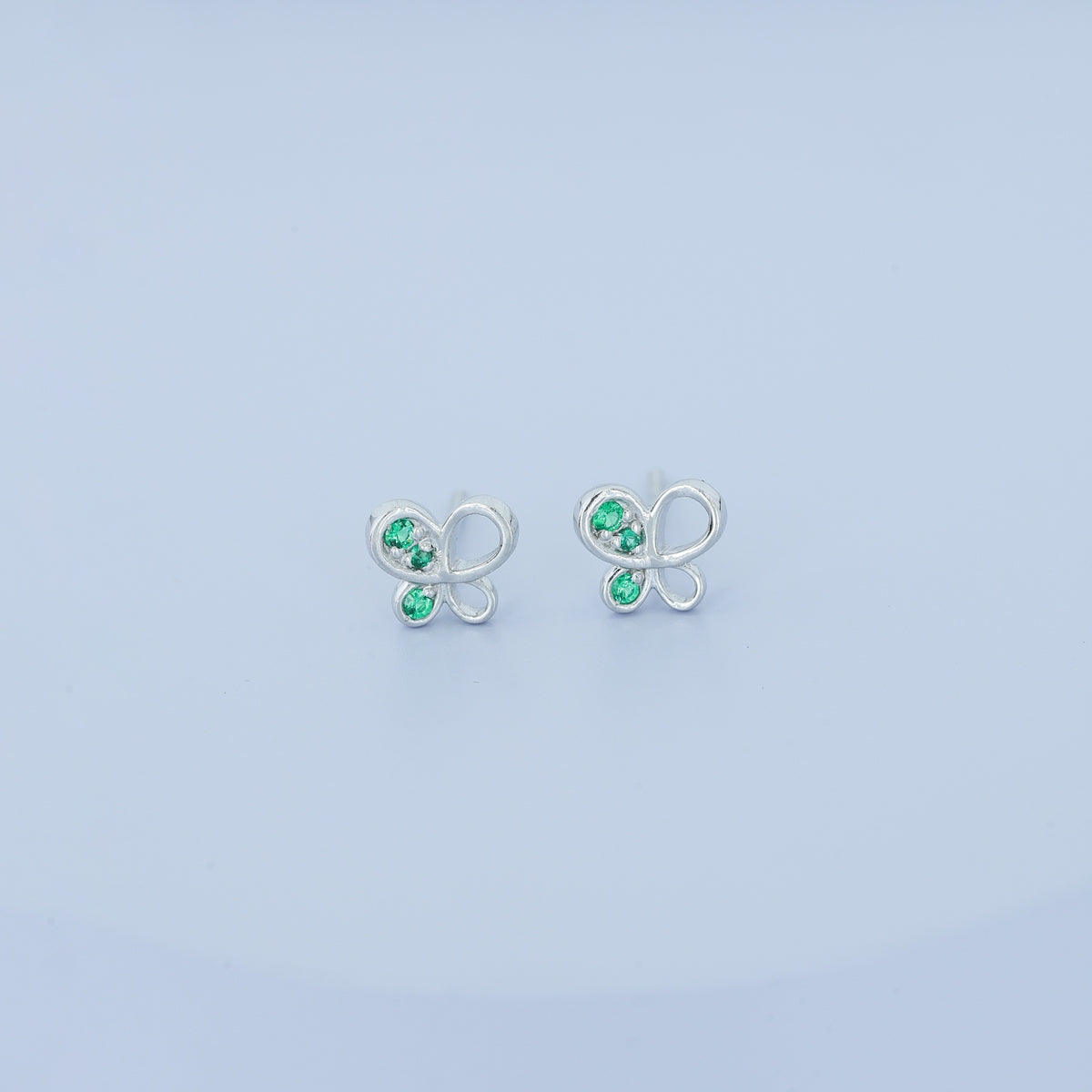 Green butterfly stud earrings with open loop wings and round green stone accents