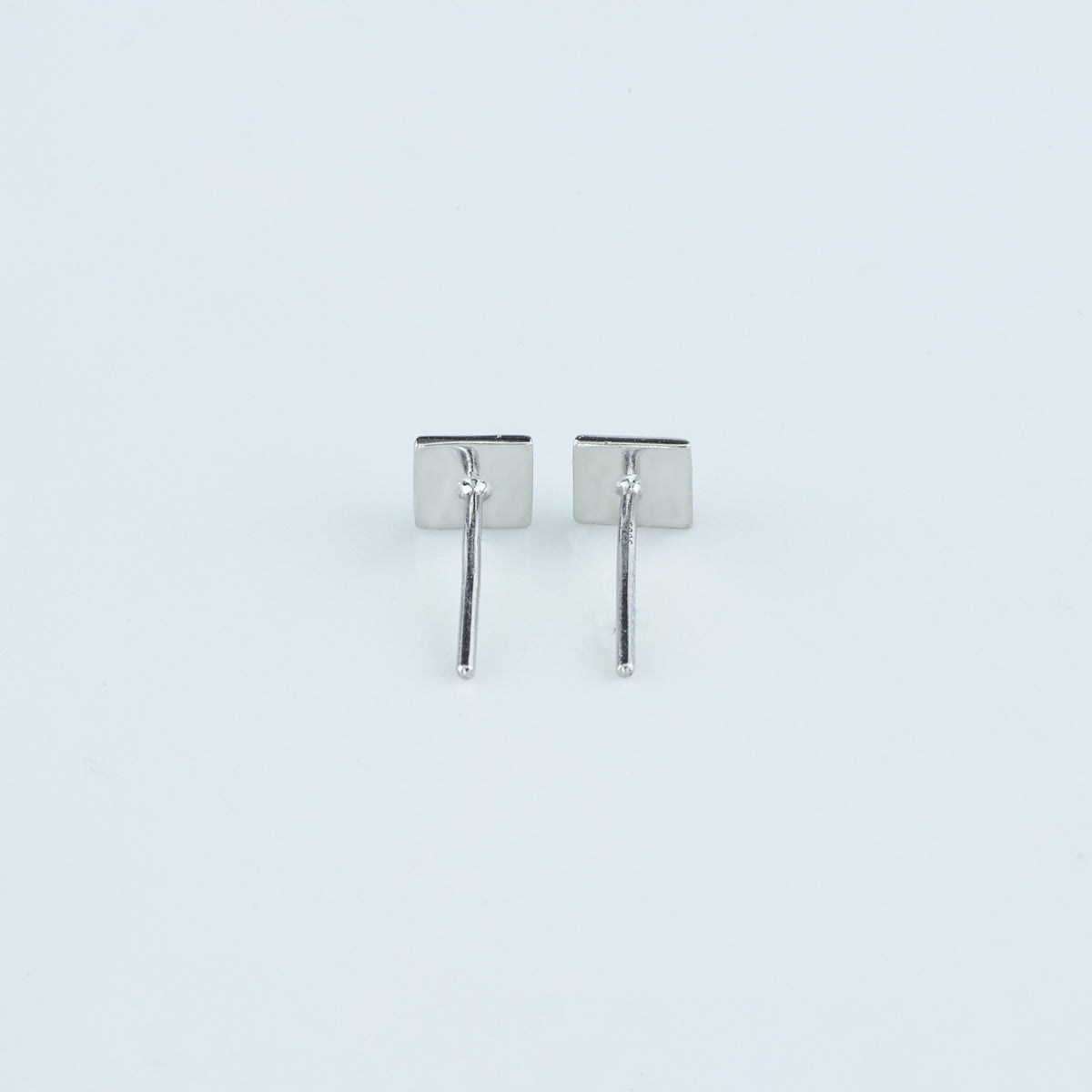 Modern pyramid stud earrings with smooth square base and raised geometric peak