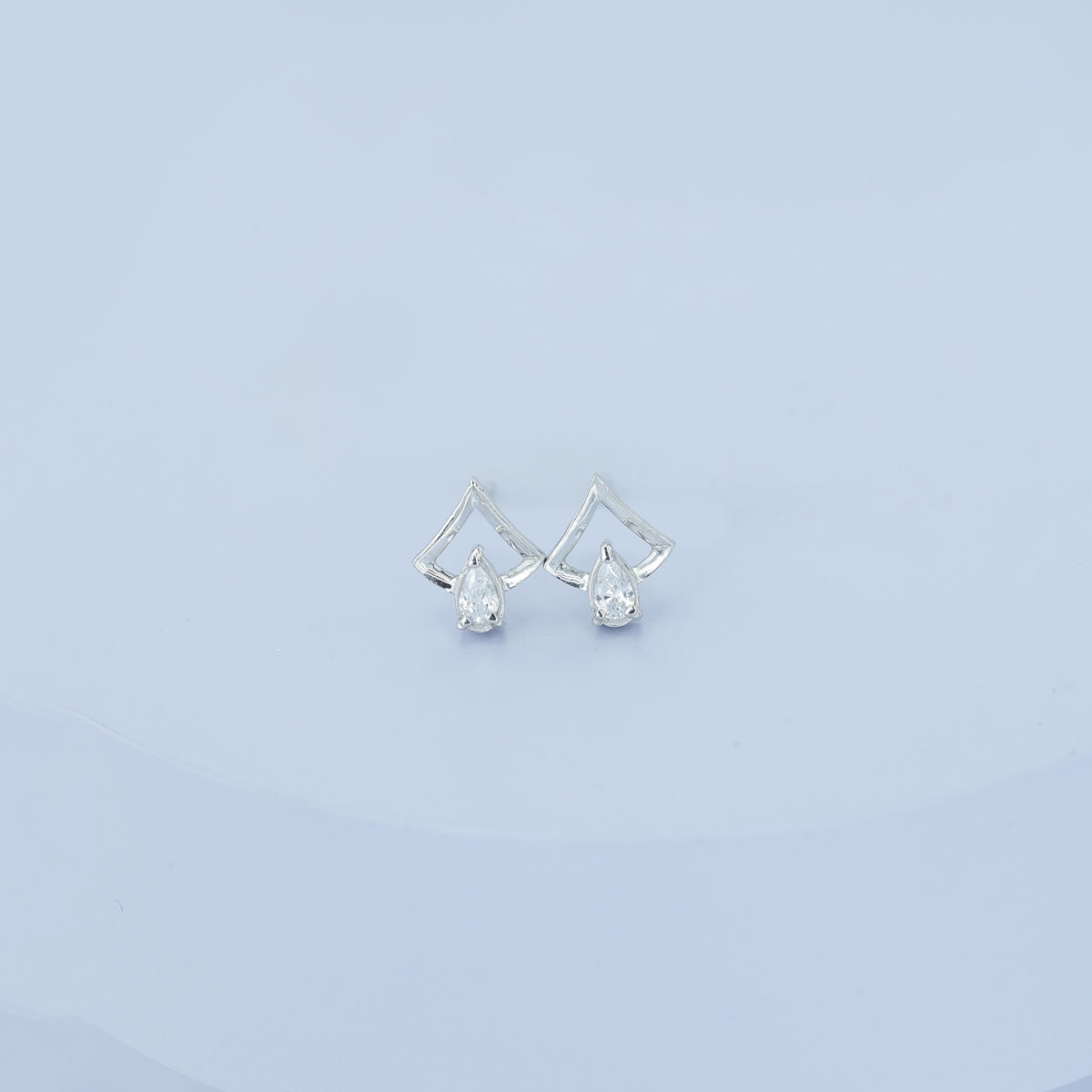 Pear drop chevron frame stud earrings with open angular top and raised stone base