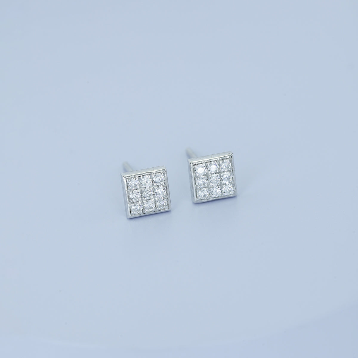 Square grid cluster stud earrings with tilted diamond shape and pave filled surface