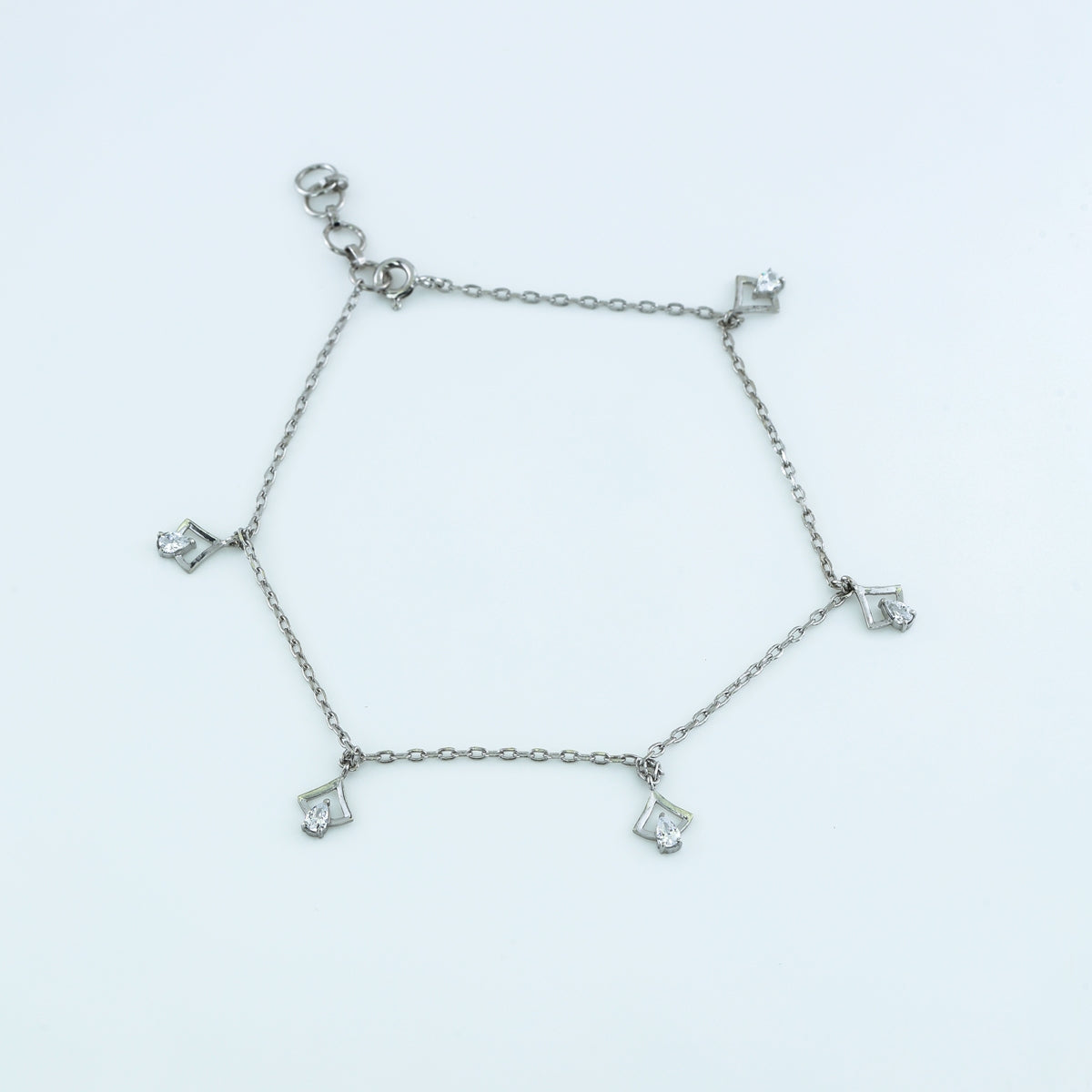 Arrow drop charm anklet with delicate chain and five dangling arrow shaped pear stone charms