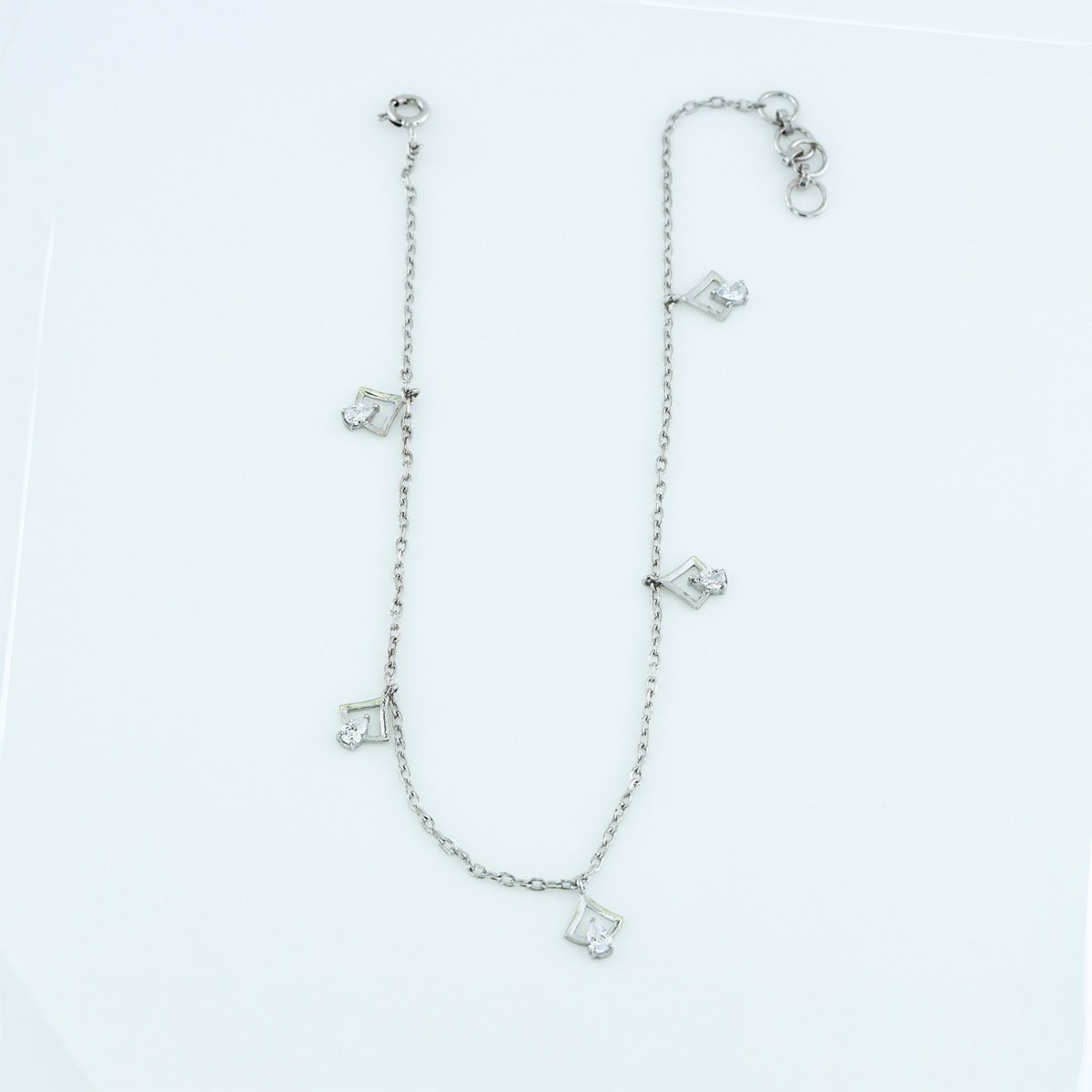 Arrow drop charm anklet with delicate chain and five dangling arrow shaped pear stone charms