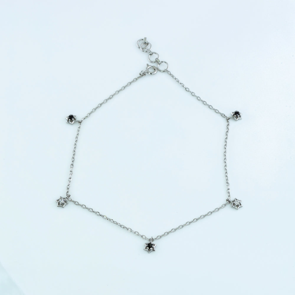 Black and white stone charm anklet with delicate chain and alternating filled and open shaped charms