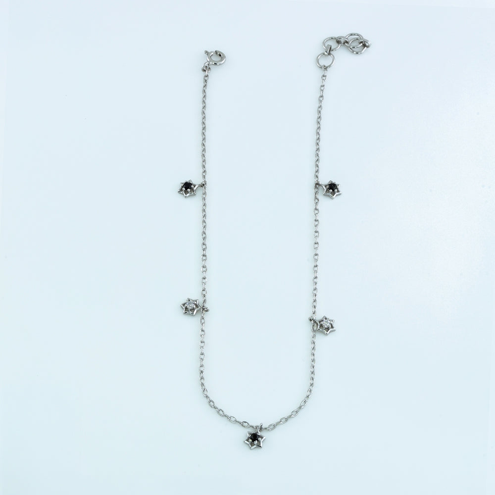 Black and white stone charm anklet with delicate chain and alternating filled and open shaped charms