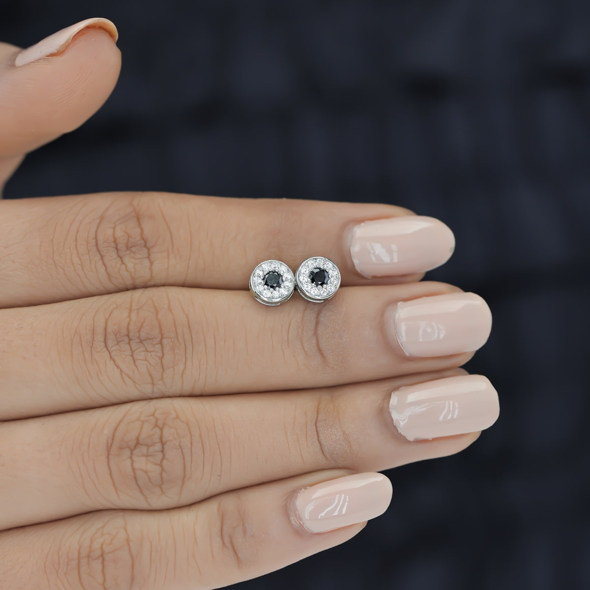 Black halo round cluster stud earrings with white pave surround and circular bezel frame