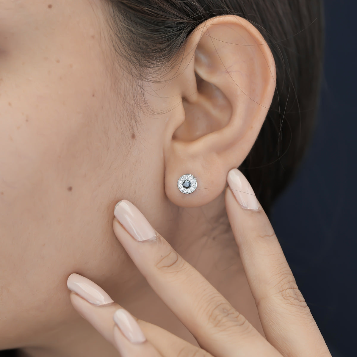 Black halo round cluster stud earrings with white pave surround and circular bezel frame