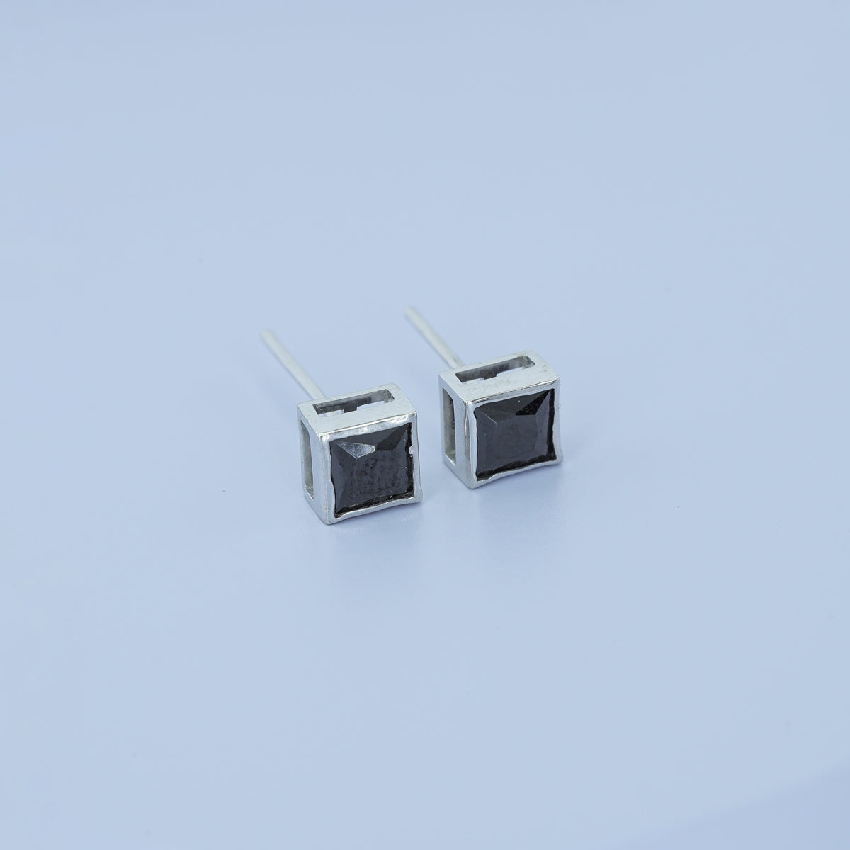 Black princess bezel stud earrings with channel set flat square frame