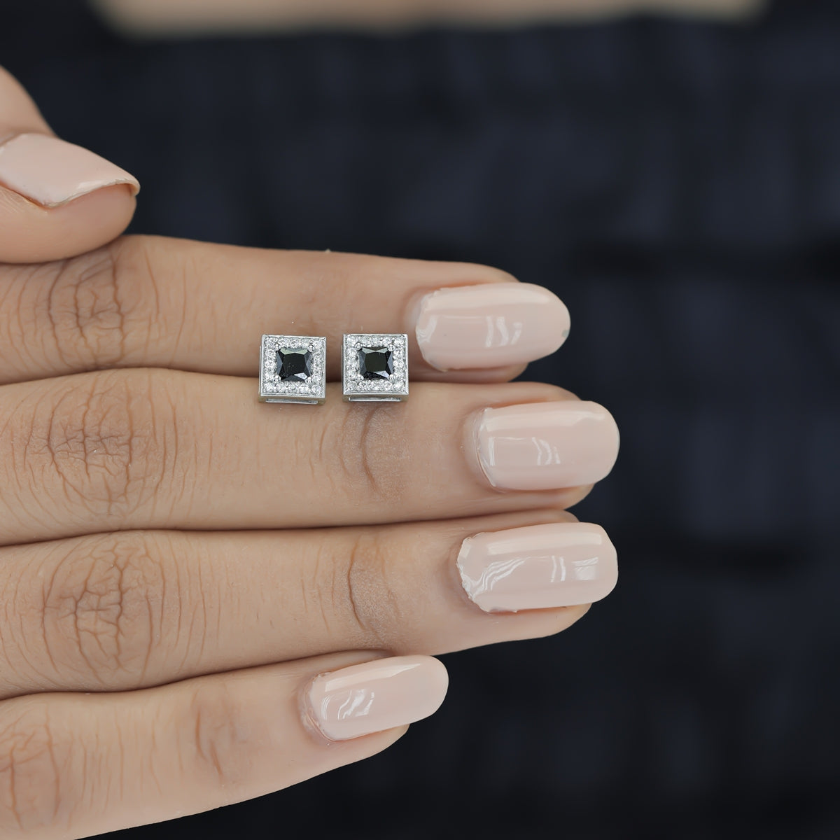 Black princess halo square stud earrings with white pave border and tilted diamond frame