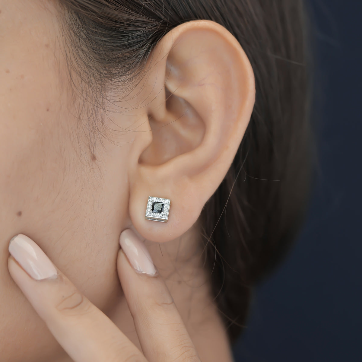 Black princess halo square stud earrings with white pave border and tilted diamond frame