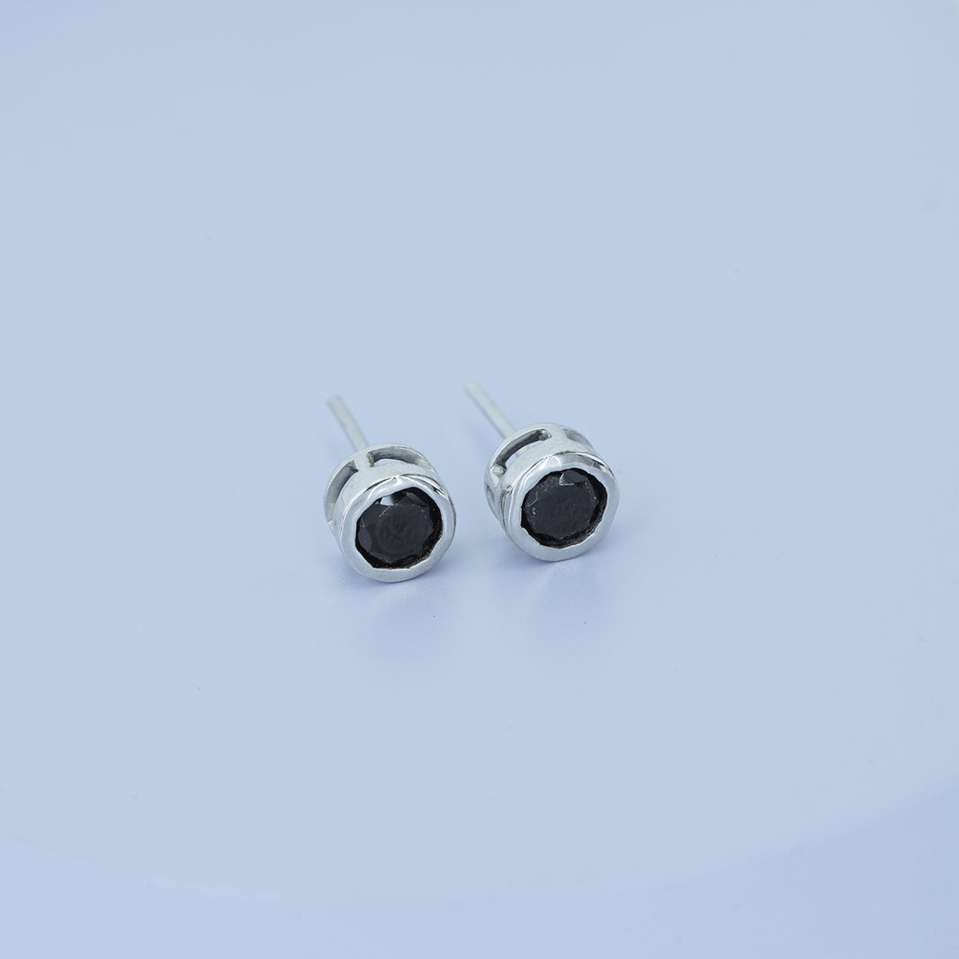 Black round stud earrings with polished circular bezel frame