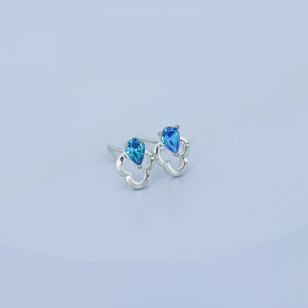 Blue pear drop floral stud earrings with open quatrefoil base and raised stone top