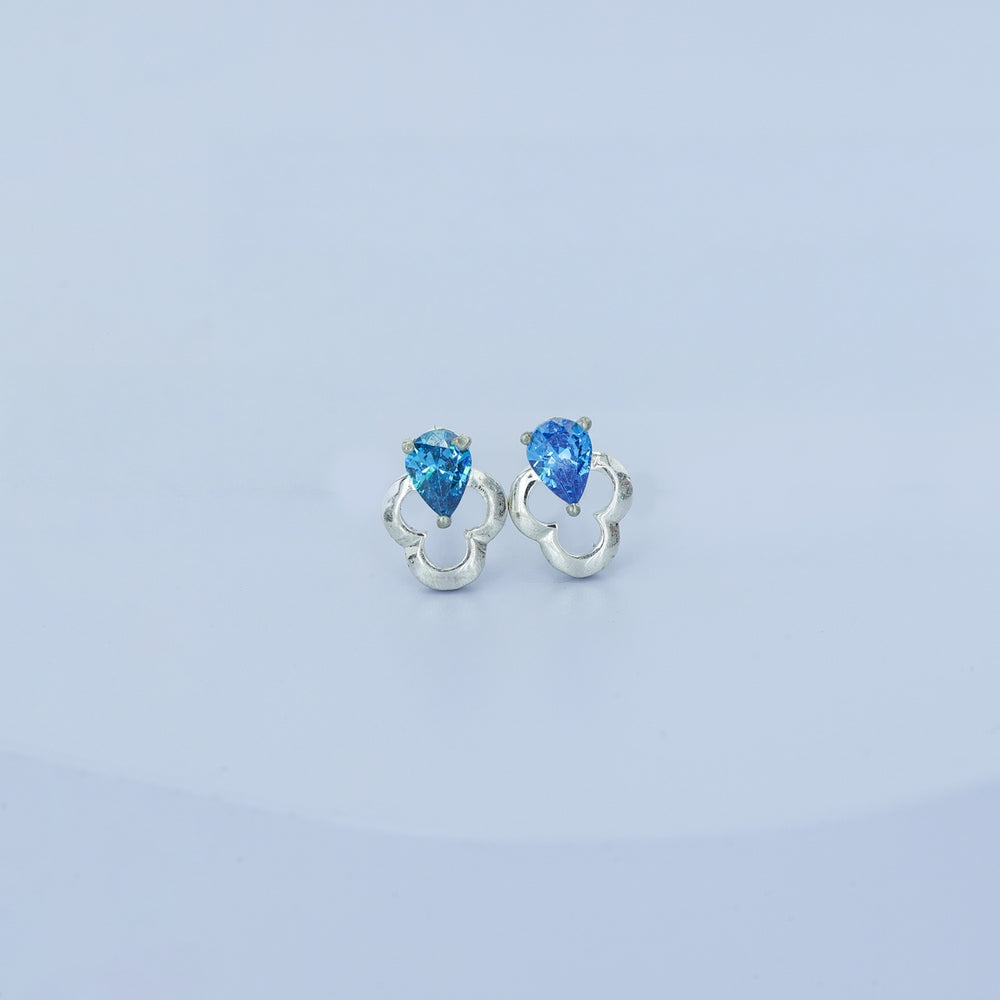 Blue pear drop floral stud earrings with open quatrefoil base and raised stone top