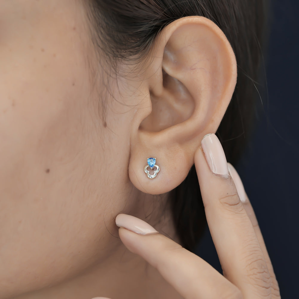 Blue pear drop floral stud earrings with open quatrefoil base and raised stone top