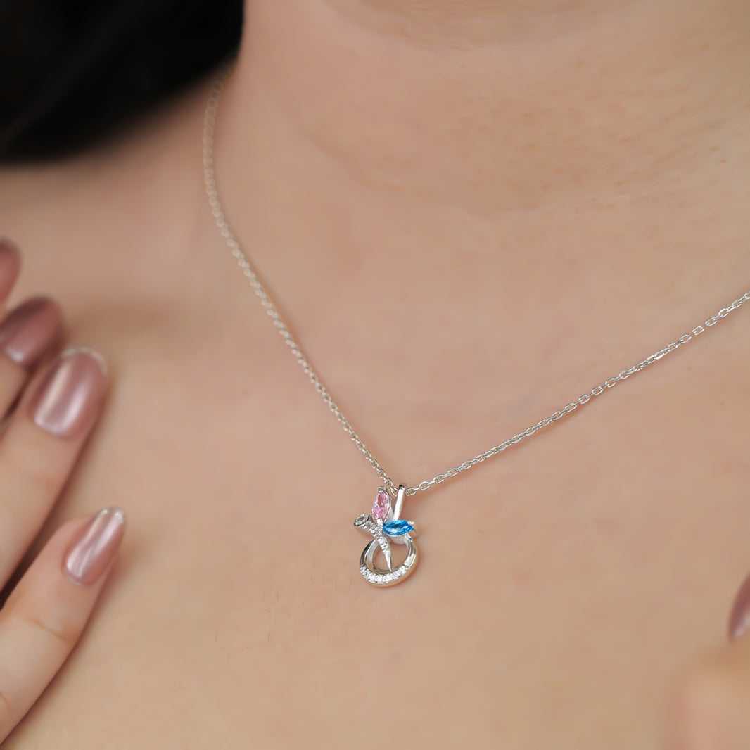 Silver chain necklace with a crescent pendant set with pink and blue stones
