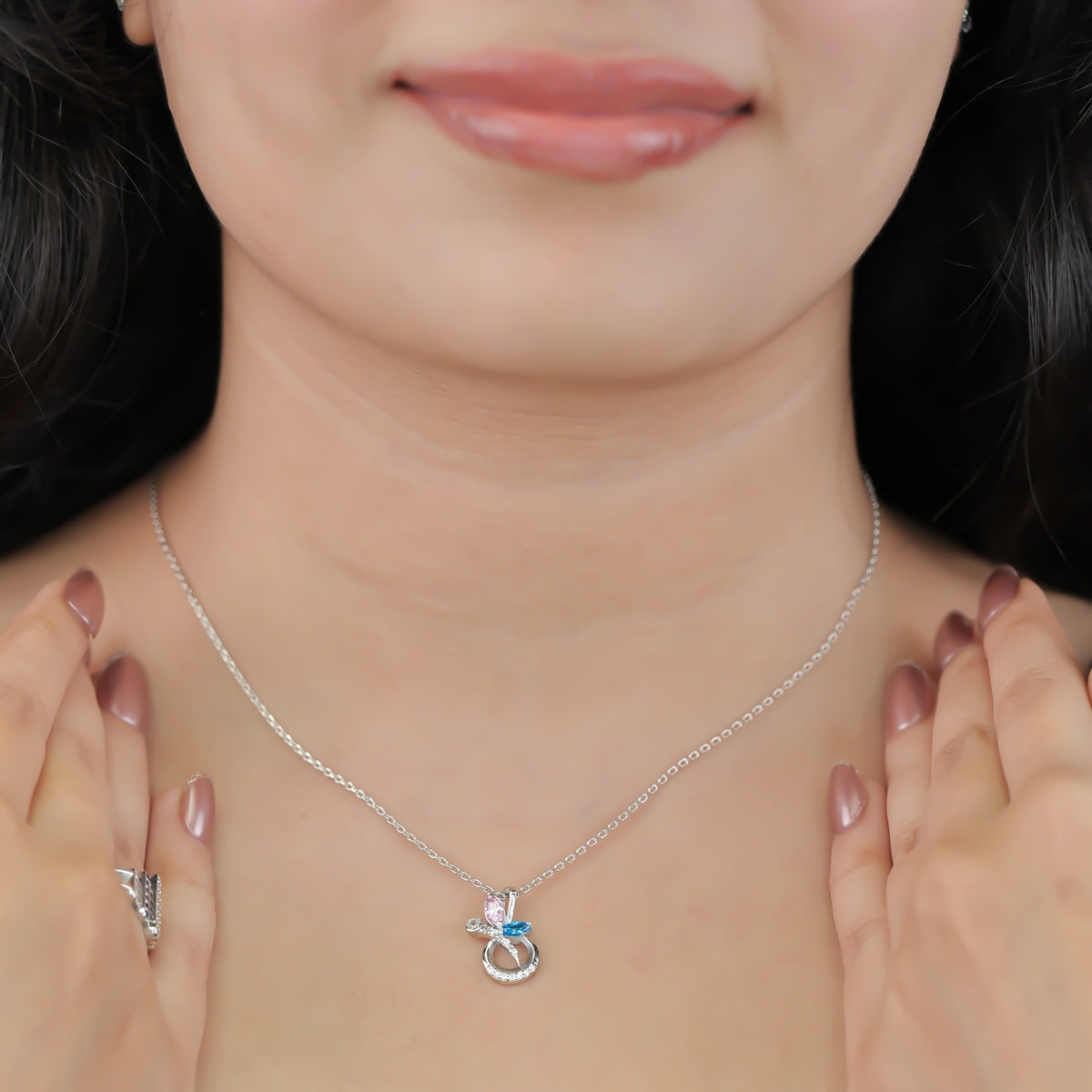 Silver chain necklace with a crescent pendant set with pink and blue stones