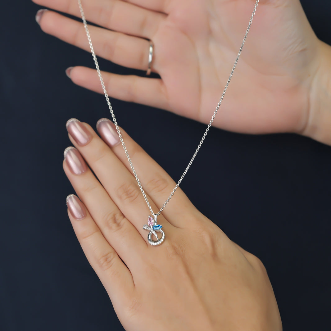 Silver chain necklace with a crescent pendant set with pink and blue stones