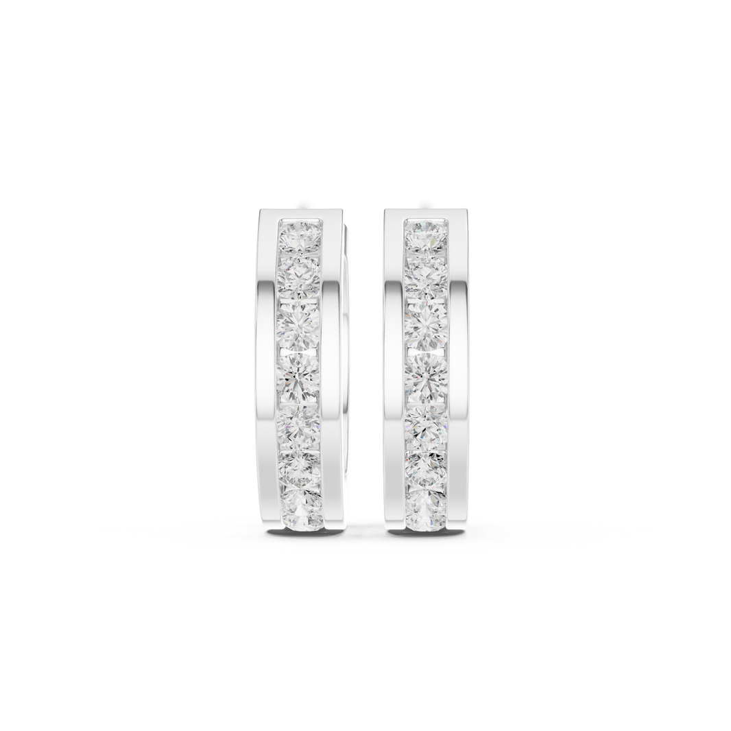 Channel set round stone huggie earrings with wide polished band and single row of channel set round stones along the centre
