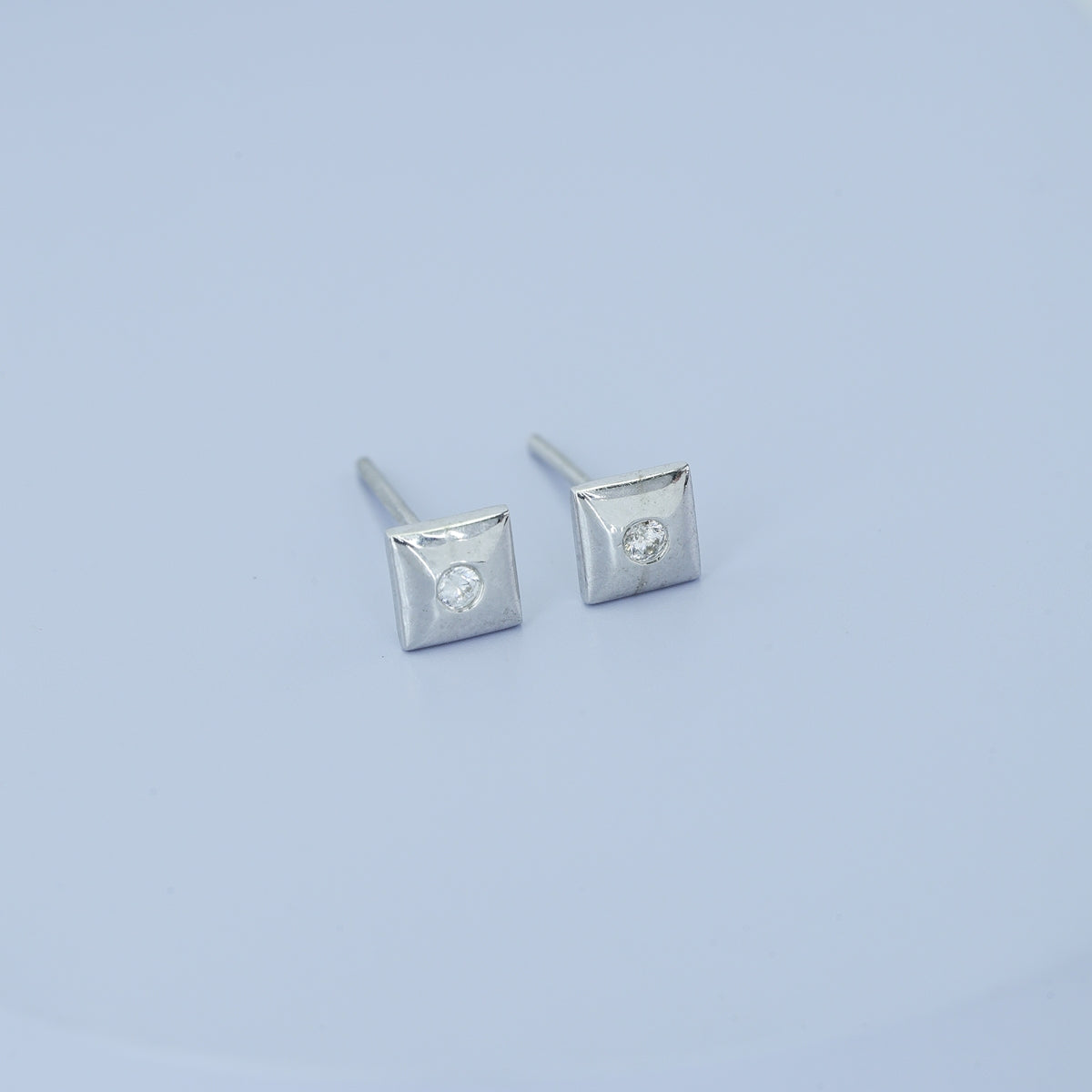 Chaukor stud earrings with diamond-shaped geometric frame and bezel-set round centre stone