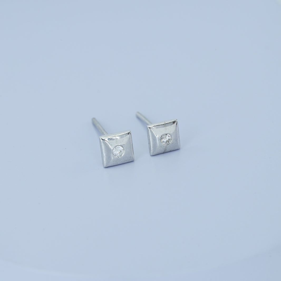 Chaukor stud earrings with diamond-shaped geometric frame and bezel-set round centre stone