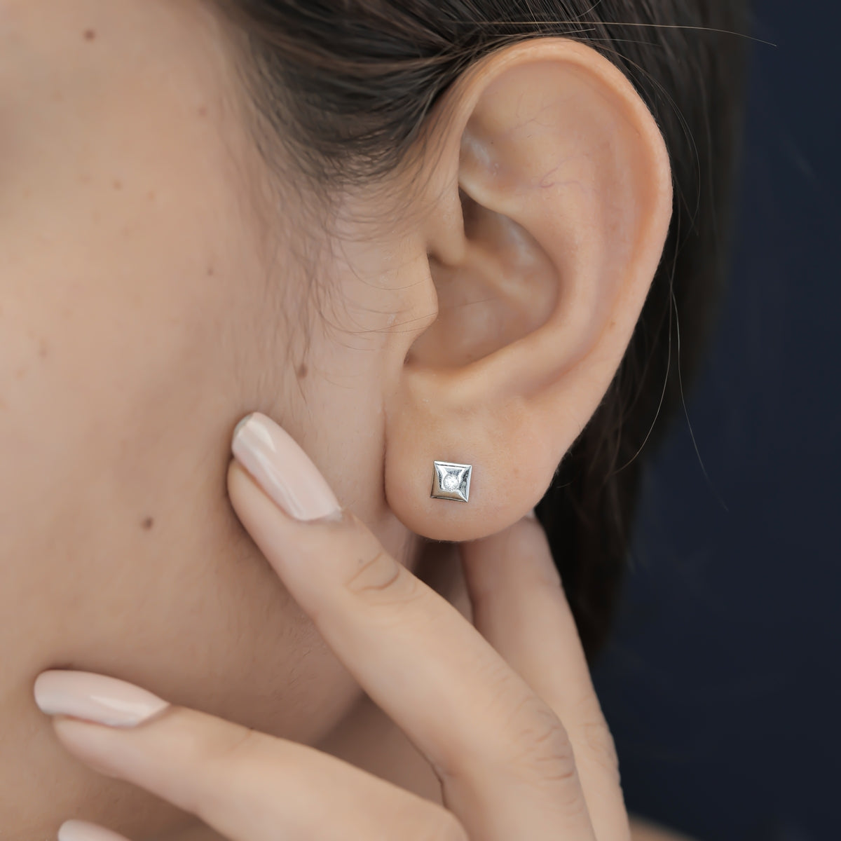 Chaukor stud earrings with diamond-shaped geometric frame and bezel-set round centre stone