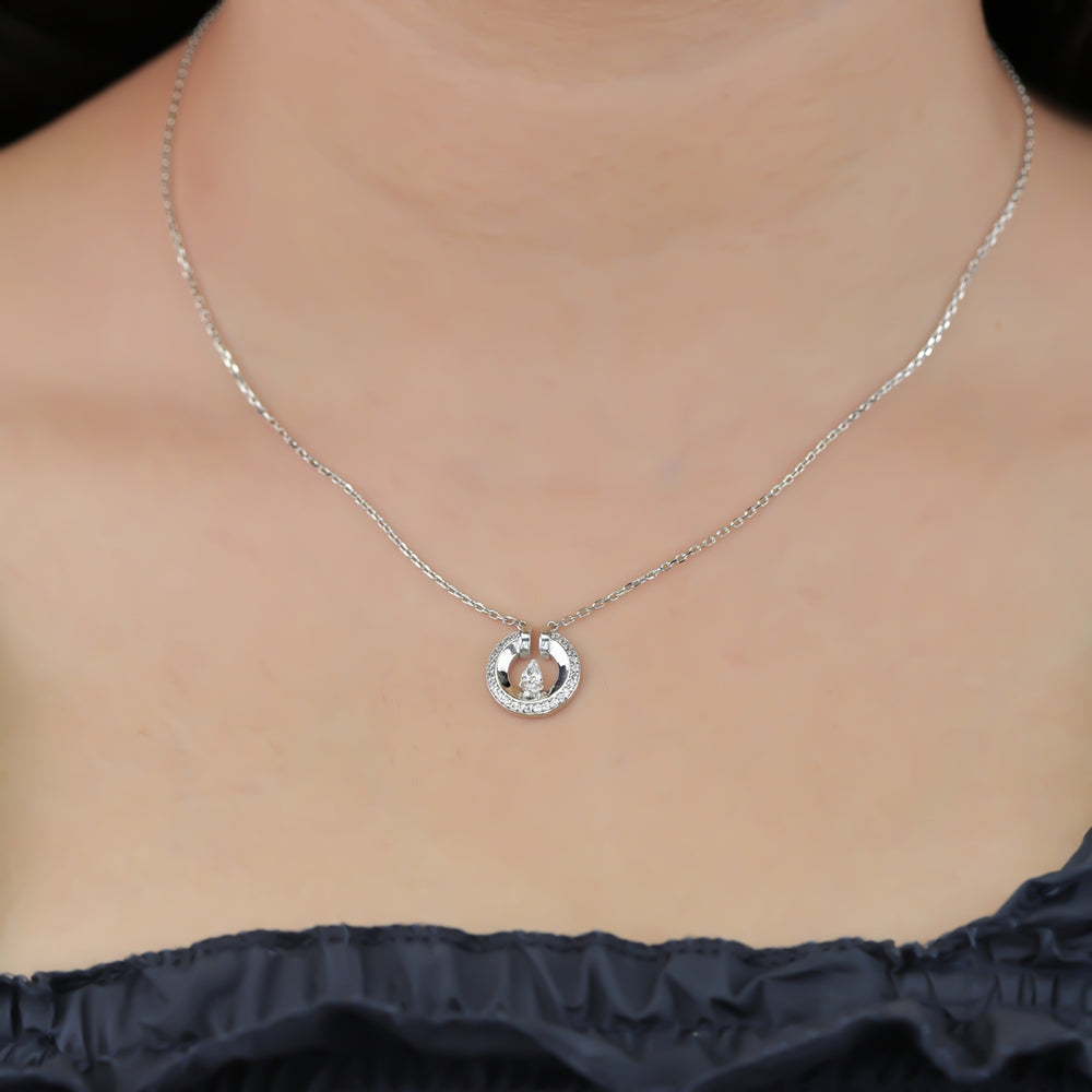 Silver chain necklace with a paved circle pendant enclosing a crystal drop