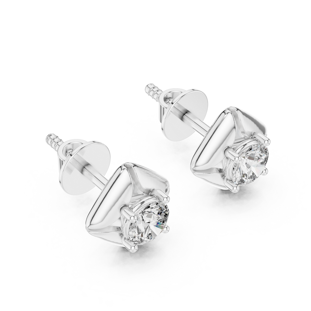 Round brilliant solitaire stud earrings within a polished cushion-shaped frame with grooved corner detailing