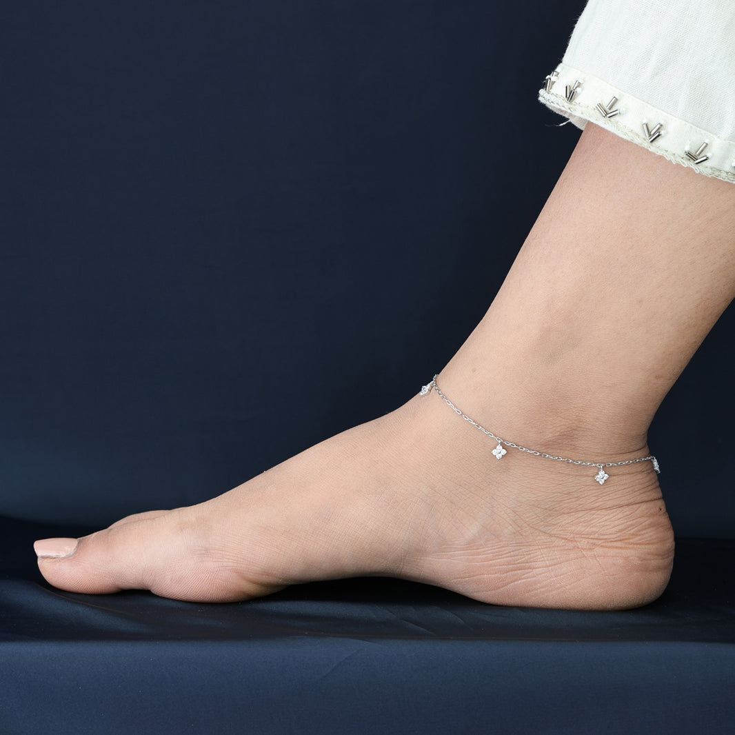 Diamond star charm anklet with delicate chain and five dangling four point star shaped stone charms