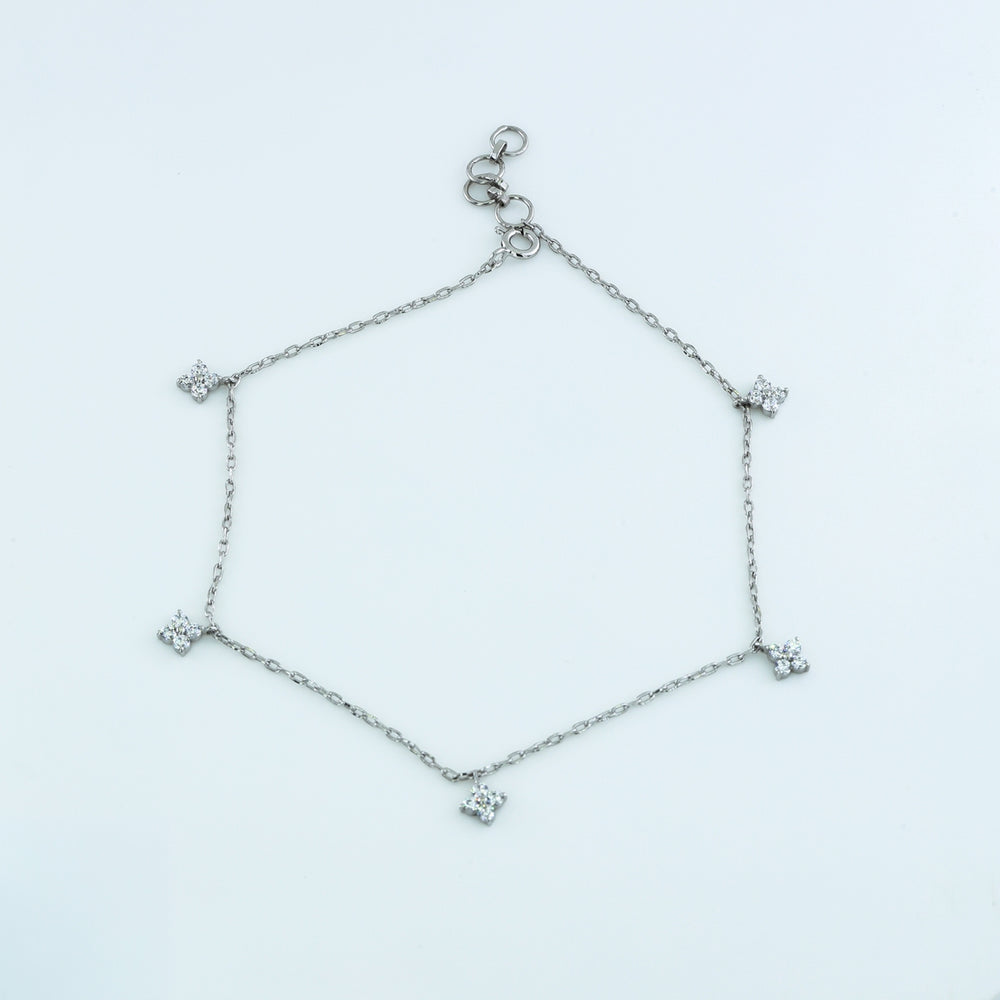 Diamond star charm anklet with delicate chain and five dangling four point star shaped stone charms