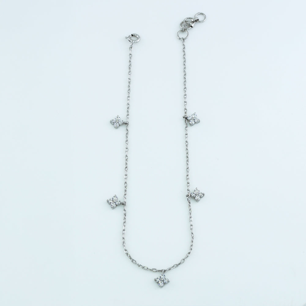 Diamond star charm anklet with delicate chain and five dangling four point star shaped stone charms