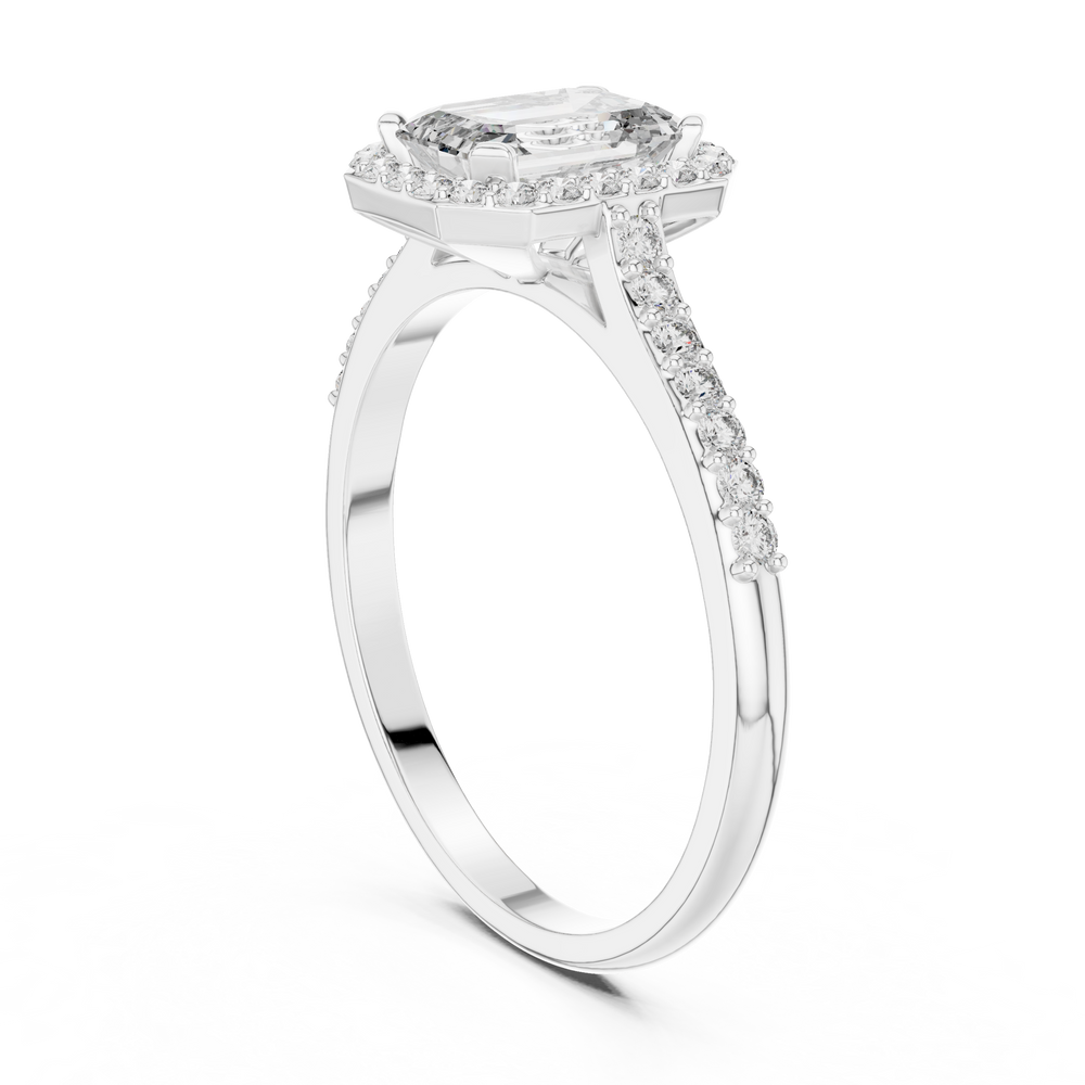 Emerald cut halo engagement ring with pave set shoulders and tapered split band