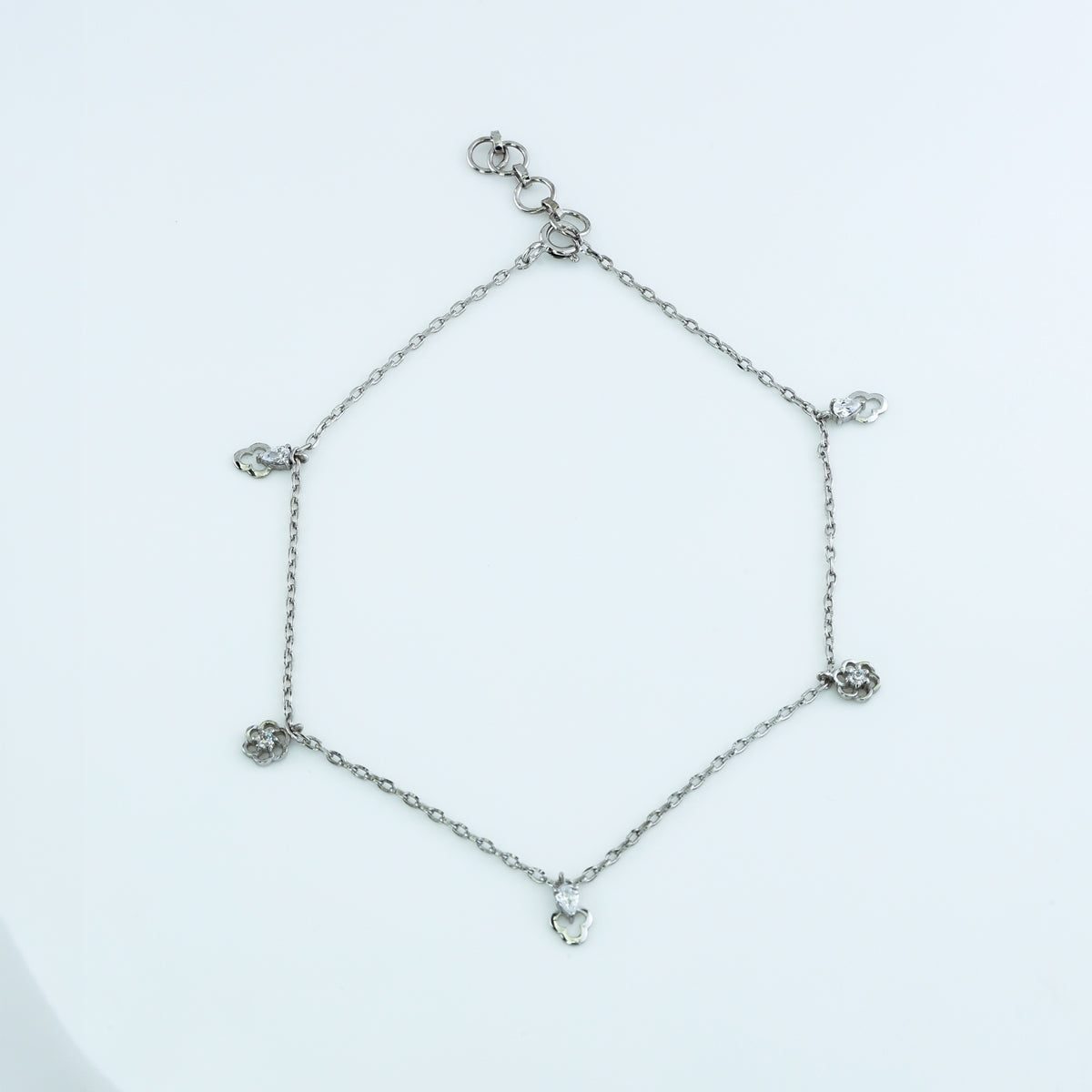 Floral and pear drop charm anklet with delicate chain and alternating flower and pear shaped dangling charms