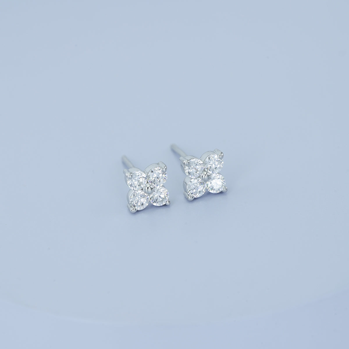 Floral diamond stud earrings with five round stones in flower cluster arrangement