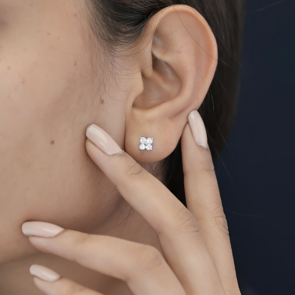 Floral diamond stud earrings with five round stones in flower cluster arrangement