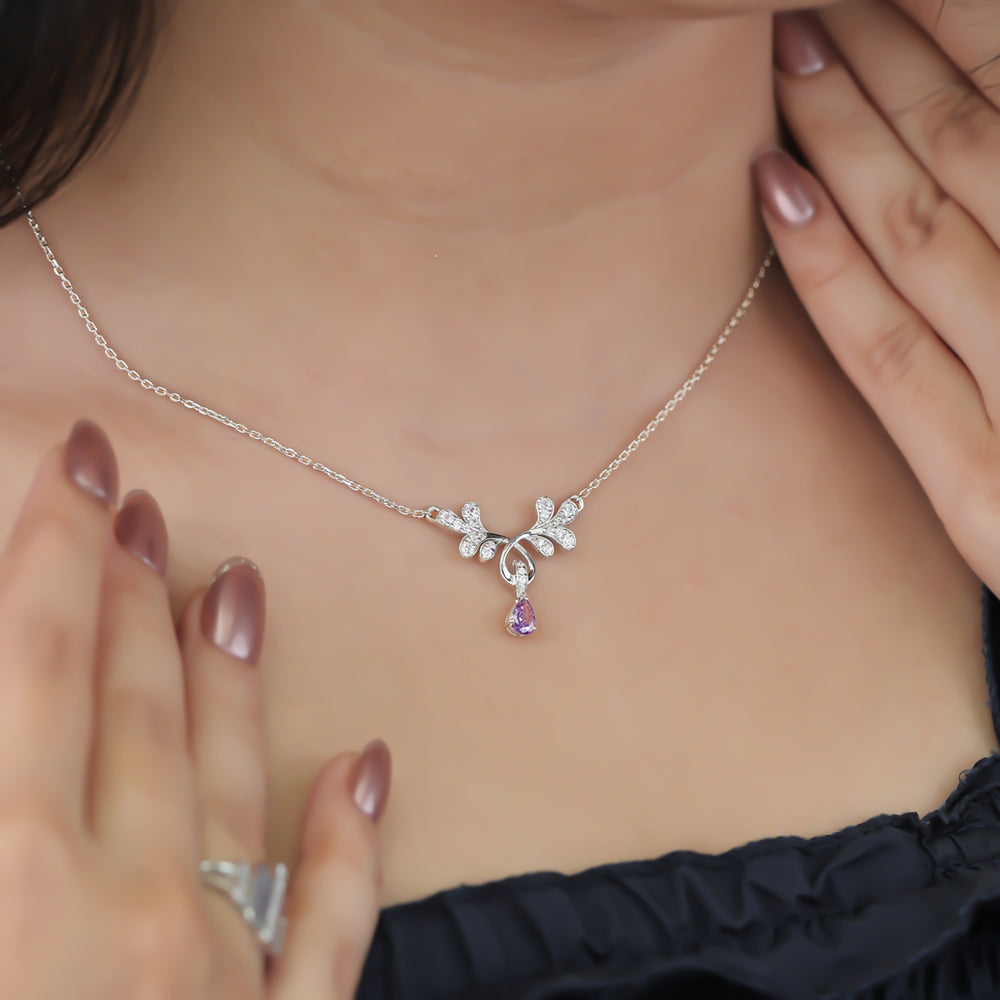 Elegant floral pendant necklace with a purple teardrop stone