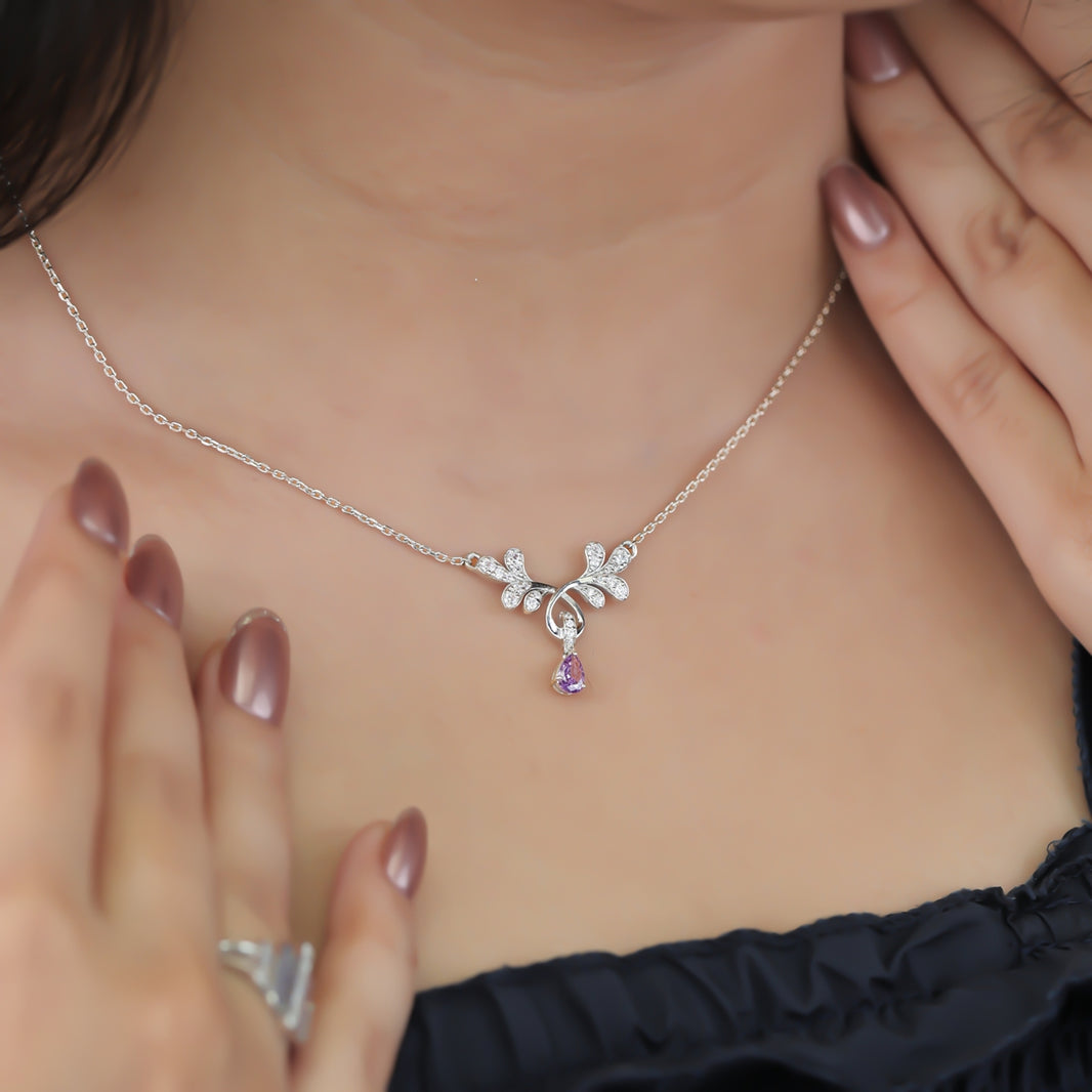 Elegant floral pendant necklace with a purple teardrop stone
