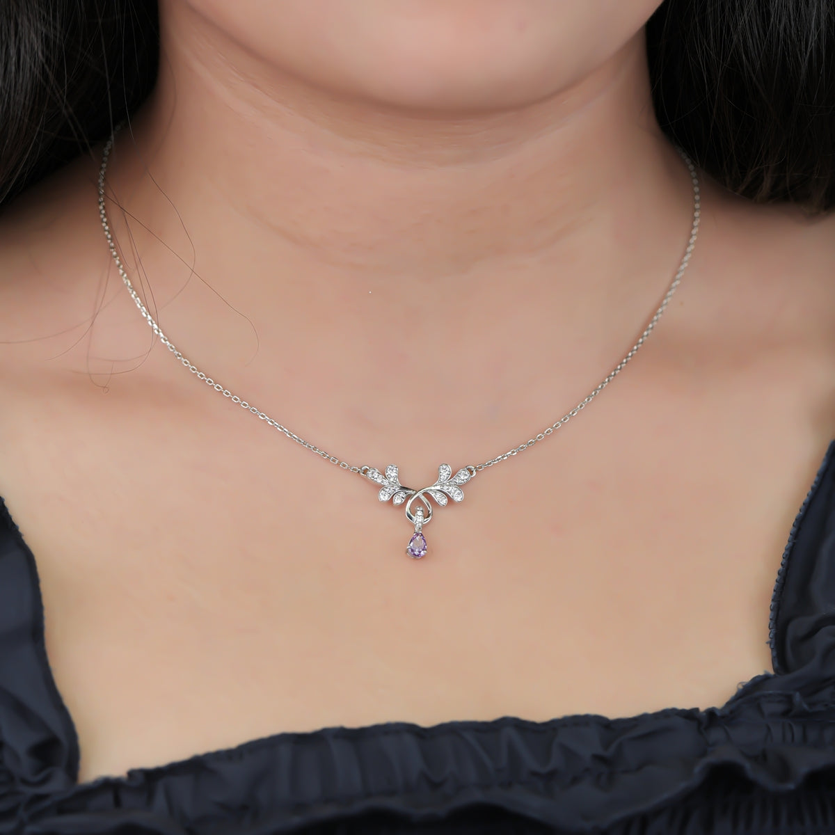 Elegant floral pendant necklace with a purple teardrop stone