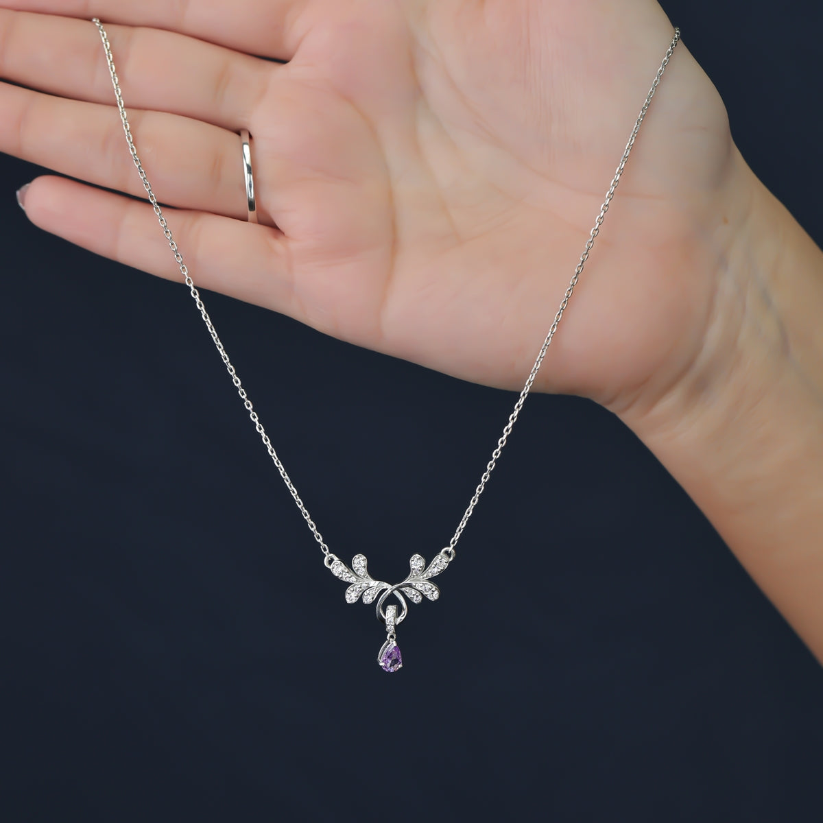 Elegant floral pendant necklace with a purple teardrop stone