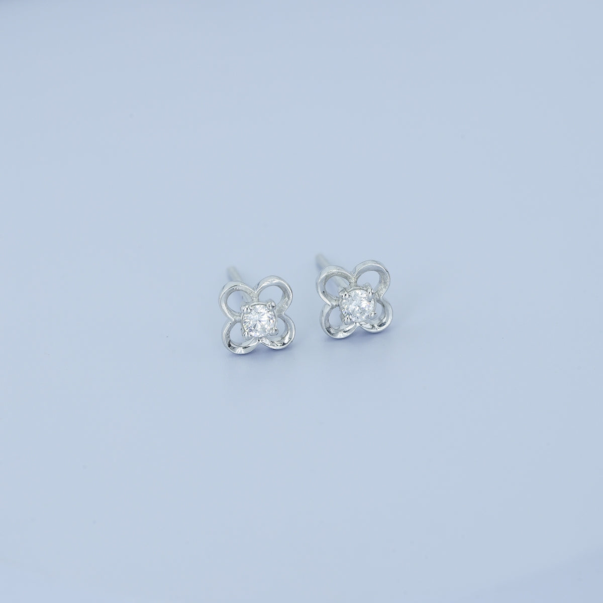 Four petal floral stud earrings with round raised centre and open petal frame