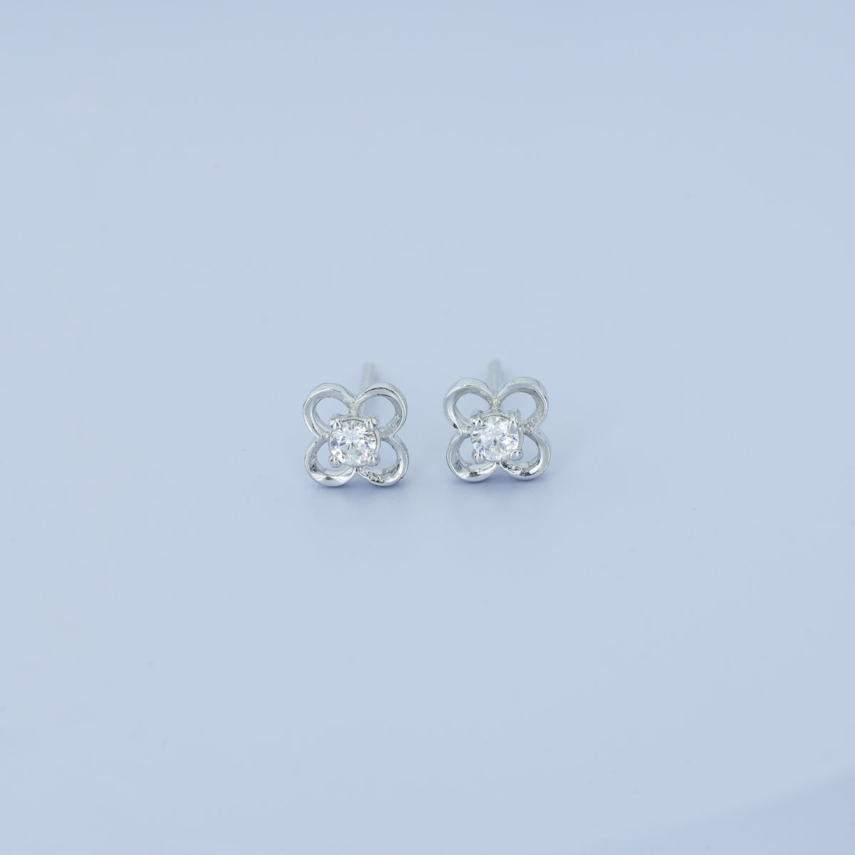Four petal floral stud earrings with round raised centre and open petal frame