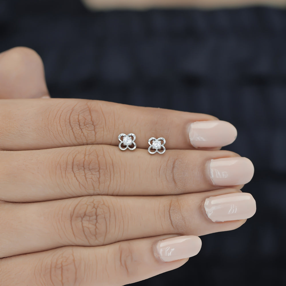 Four petal floral stud earrings with round raised centre and open petal frame