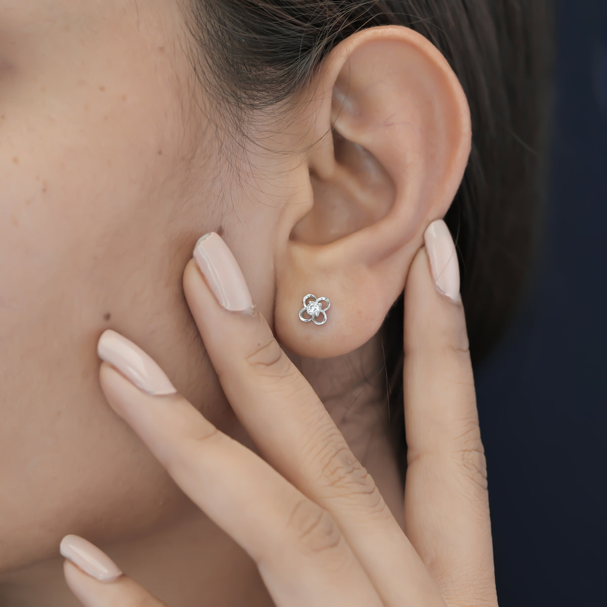 Four petal floral stud earrings with round raised centre and open petal frame