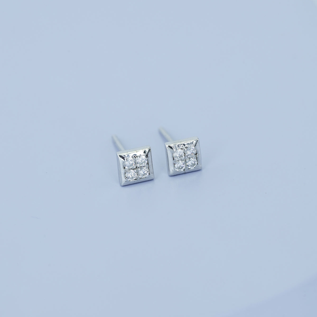 Four stone square cluster stud earrings with tilted diamond shape flat frame