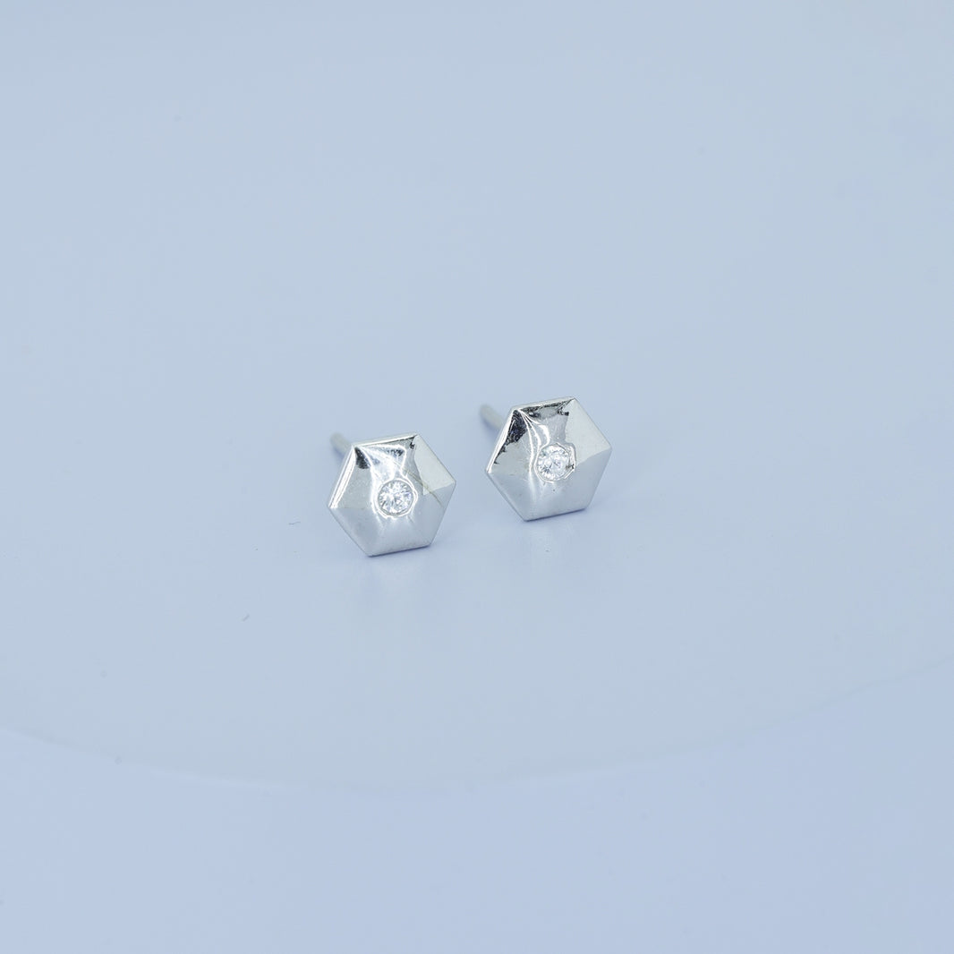 Geometric cube solitaire stud earrings with hexagonal frame and round centre stone