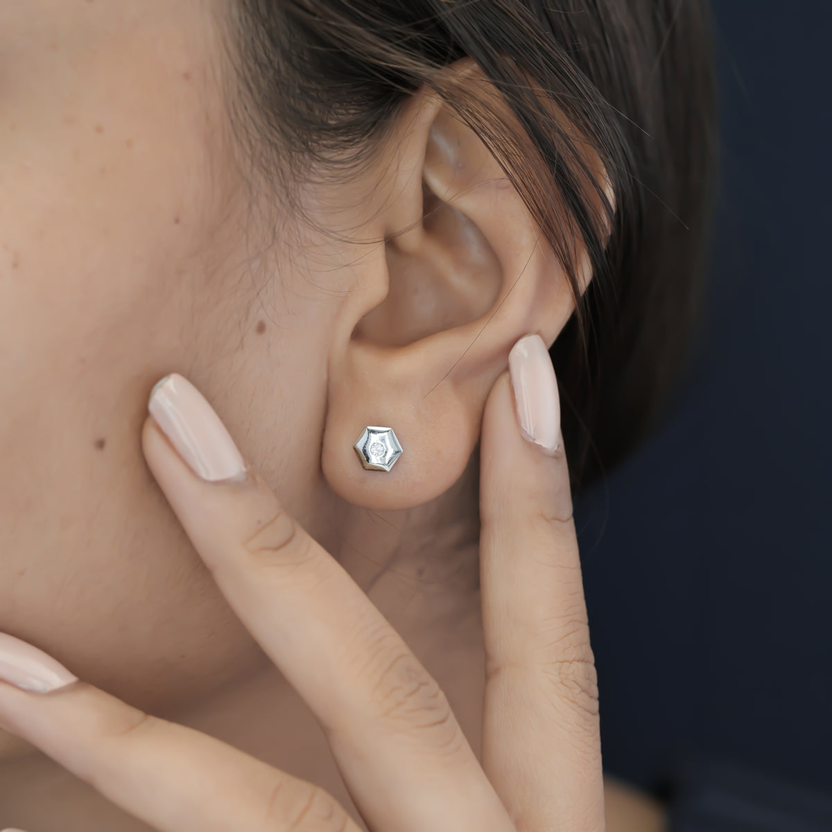 Geometric cube solitaire stud earrings with hexagonal frame and round centre stone