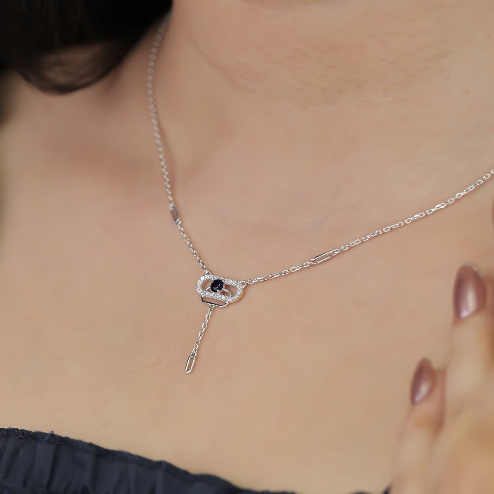 Delicate necklace featuring a pavé oval frame centered with a dark crystal drop