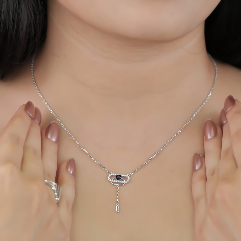 Delicate necklace featuring a pavé oval frame centered with a dark crystal drop