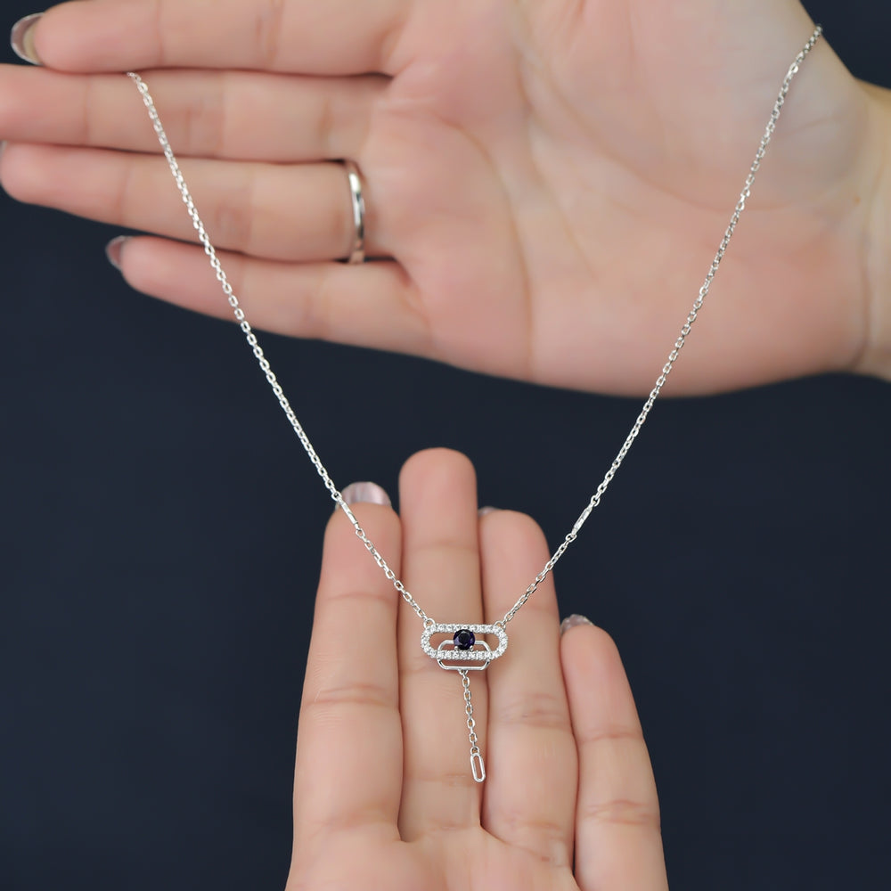 Delicate necklace featuring a pavé oval frame centered with a dark crystal drop